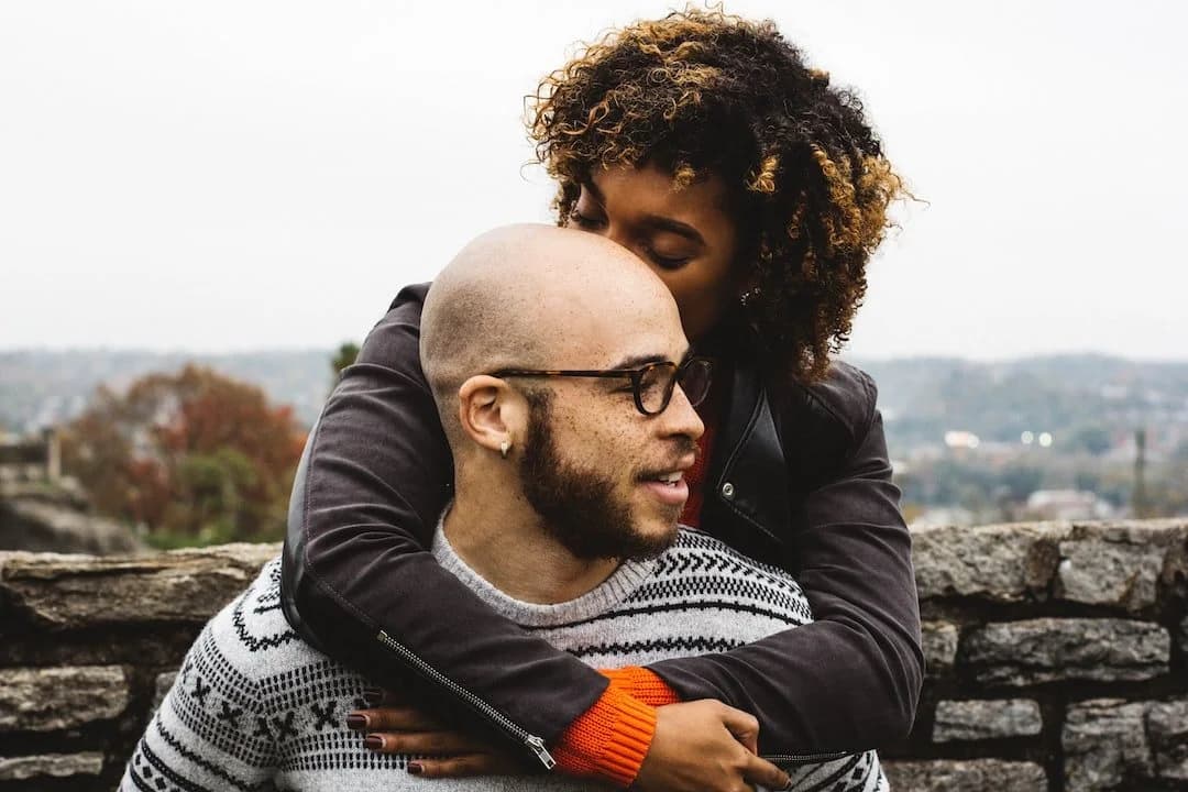 A couple sitting close together at home